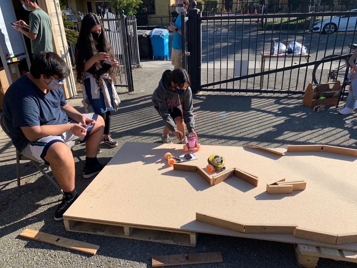 Hope Horizon students working together on a robotics activity outdoors