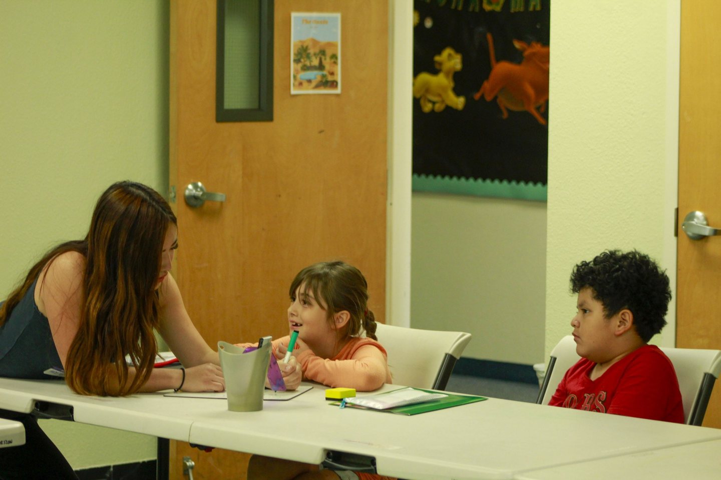 A Hope Horizon tutor and a student laughing together during a tutoring session