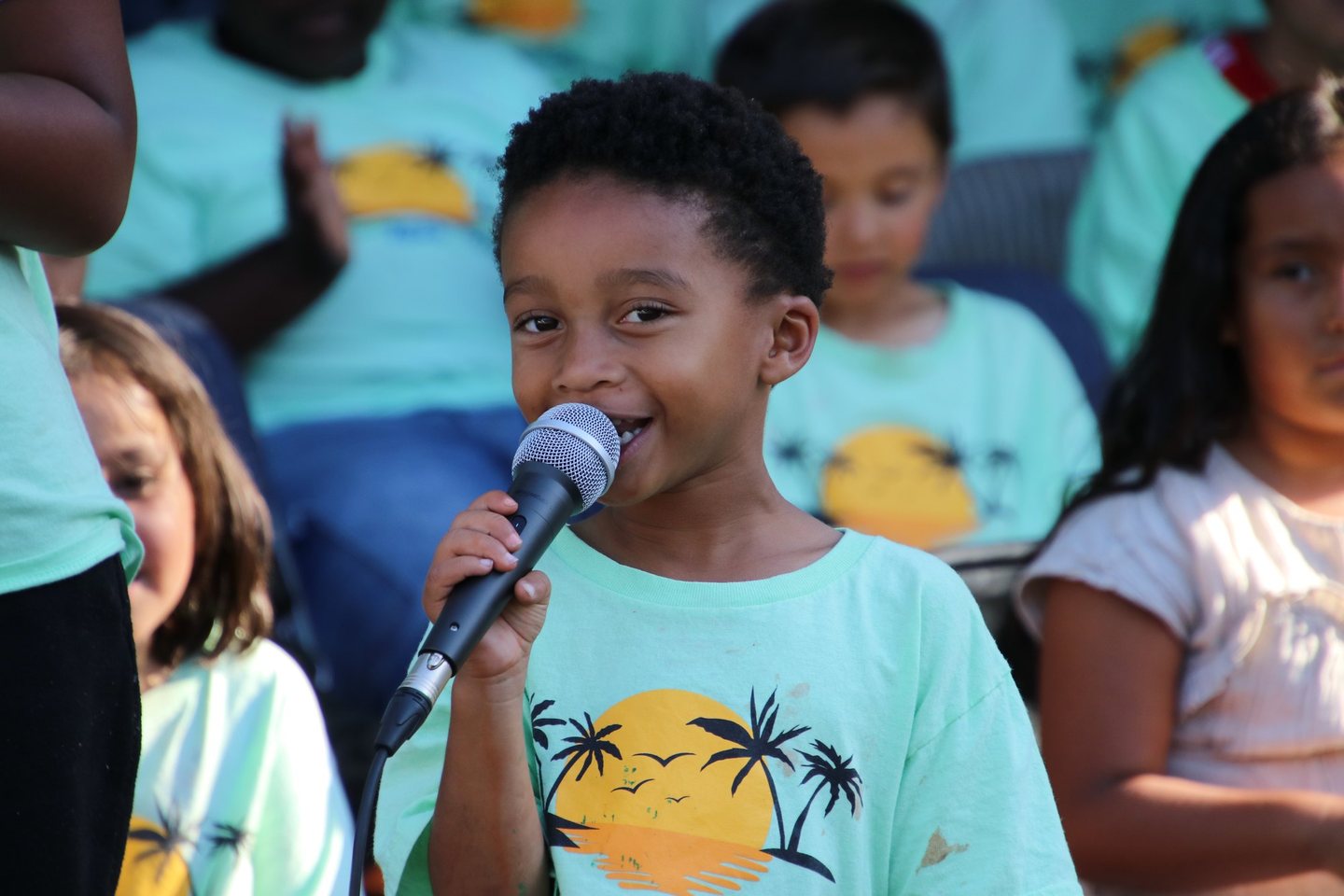 A Hope Horizon camper speaking into a microphone