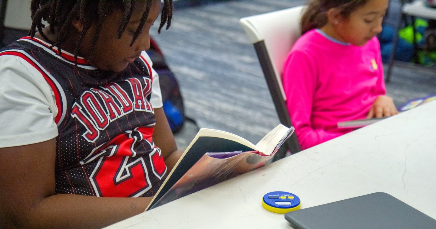A Hope Horizon student focused on a book at her desk